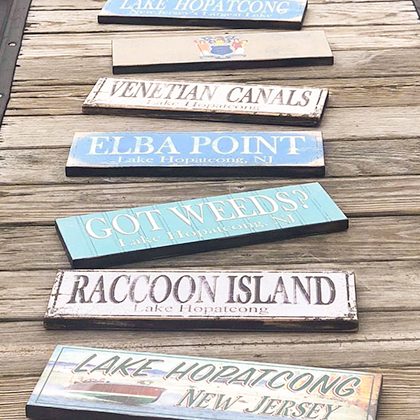 A variety of lake signs laid out on a dock.